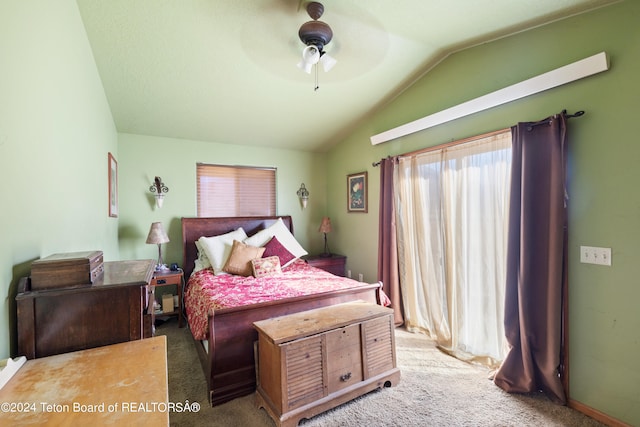 bedroom with vaulted ceiling, ceiling fan, and carpet flooring