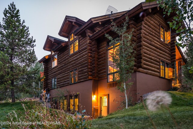 view of side of home featuring log siding