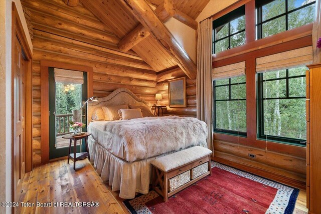 bedroom featuring hardwood / wood-style floors, high vaulted ceiling, wooden ceiling, beamed ceiling, and multiple windows