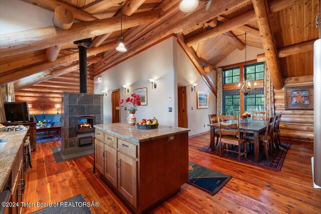 kitchen featuring dark wood finished floors, high vaulted ceiling, wood ceiling, and light stone countertops