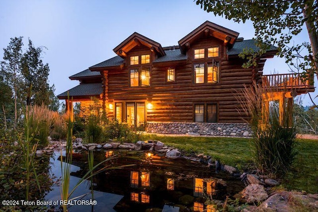 rear view of property with log siding