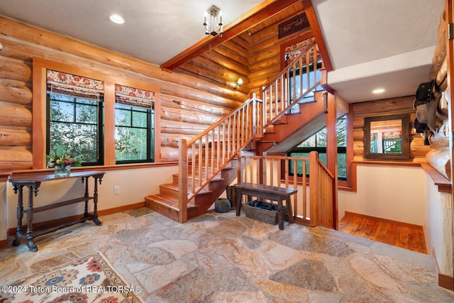 stairway featuring recessed lighting, stone finish flooring, and baseboards