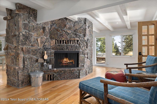 3705 W Mccollister Dr, Teton Village, WY 83025 - living room with a fireplace, wood finished floors, and beam ceiling