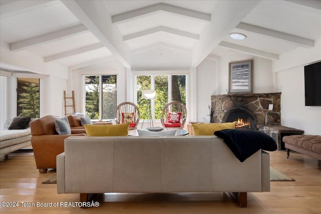 3705 W Mccollister Dr, Teton Village, WY 83025 - living room with lofted ceiling with beams, a healthy amount of sunlight, a fireplace, and light wood-type flooring