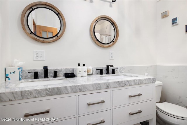 3705 W Mccollister Dr, Teton Village, WY 83025 - full bath featuring tile walls, double vanity, a sink, and toilet