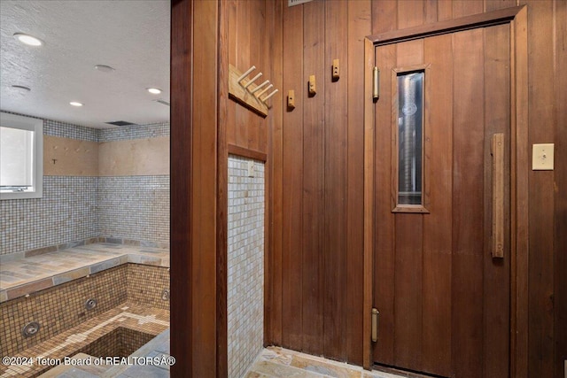 3705 W Mccollister Dr, Teton Village, WY 83025 - interior space featuring wood walls and a textured ceiling