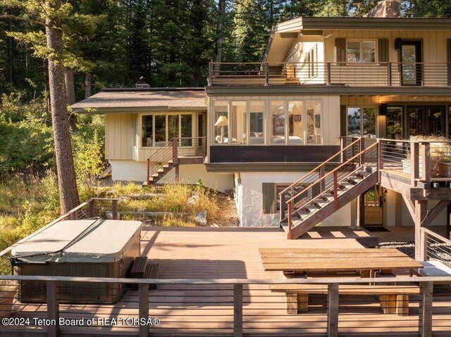 3705 W Mccollister Dr, Teton Village, WY 83025 - rear view of property with a covered hot tub, a balcony, and stairway