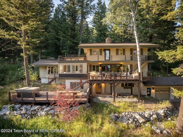 3705 W Mccollister Dr, Teton Village, WY 83025 - rear view of house featuring stairway, board and batten siding, a balcony, a garage, and a chimney