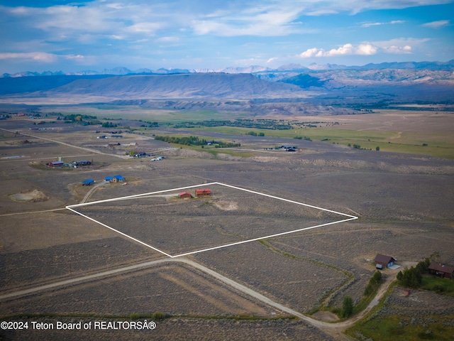 drone / aerial view featuring a mountain view and a rural view