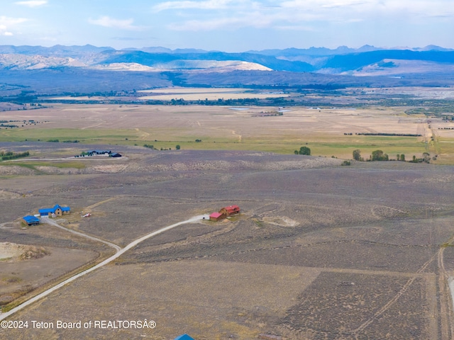 birds eye view of property featuring a mountain view and a rural view