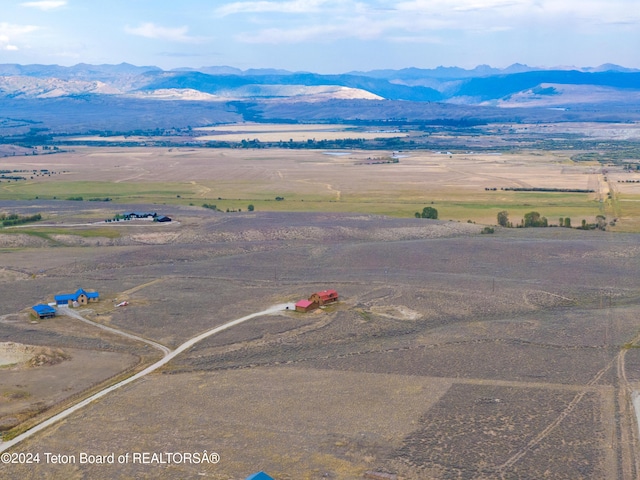 drone / aerial view featuring a water and mountain view and a rural view