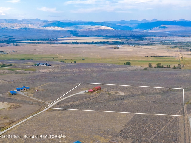 drone / aerial view featuring a mountain view and a rural view