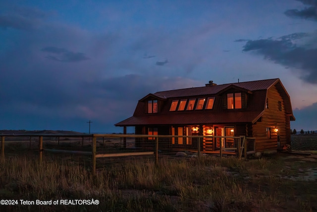 view of back house at dusk