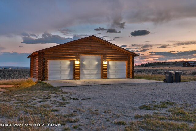 view of garage at dusk