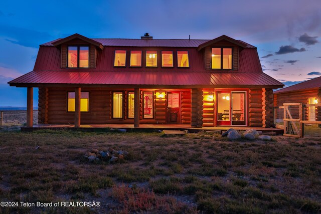 back house at dusk with a yard