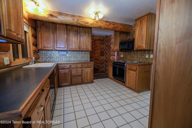 kitchen with electric range, a textured ceiling, light tile patterned flooring, and sink