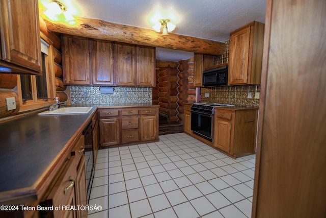 kitchen with tasteful backsplash, brown cabinets, black appliances, and a sink