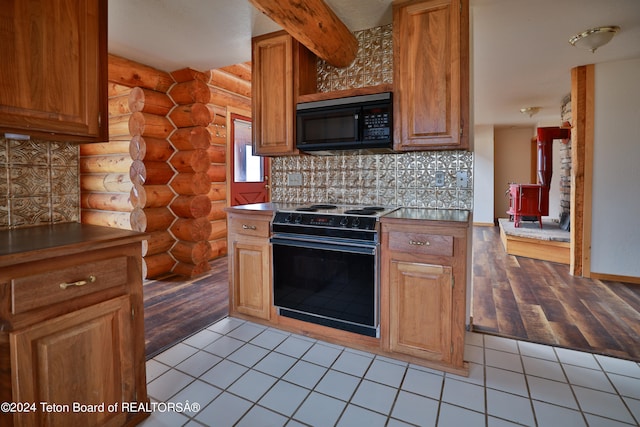 kitchen with log walls, range with electric stovetop, decorative backsplash, butcher block counters, and light wood-type flooring