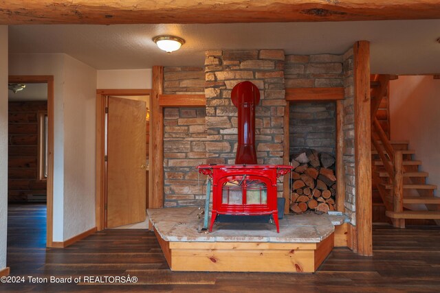 interior details with hardwood / wood-style floors and a wood stove