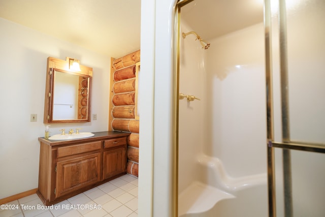 bathroom featuring vanity, walk in shower, and tile patterned flooring