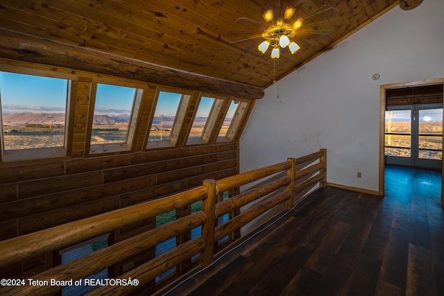 hallway featuring baseboards, dark wood finished floors, lofted ceiling, wood ceiling, and a wealth of natural light