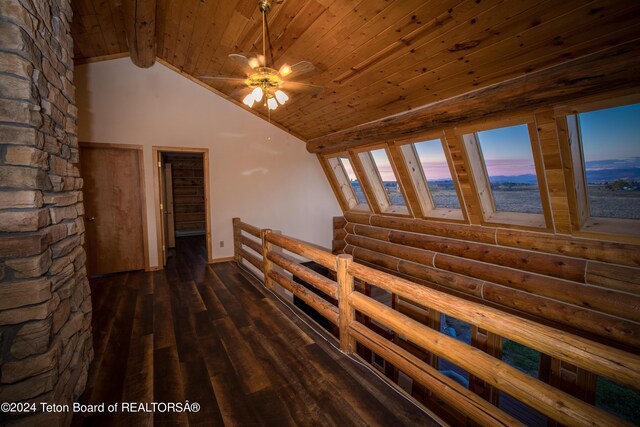 stairs featuring hardwood / wood-style floors, wood ceiling, rustic walls, ceiling fan, and lofted ceiling with beams