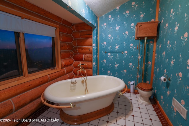 bathroom featuring a textured ceiling, visible vents, a freestanding bath, and wallpapered walls