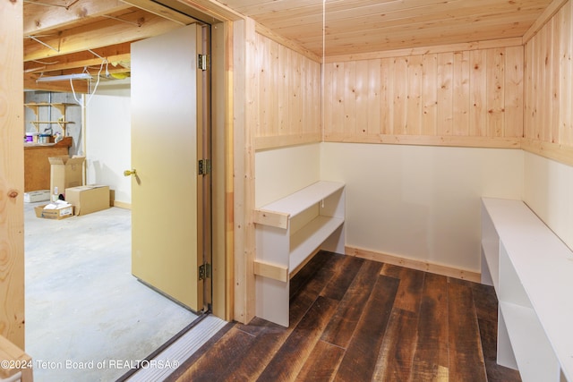 view of sauna with wooden ceiling, concrete flooring, and wooden walls