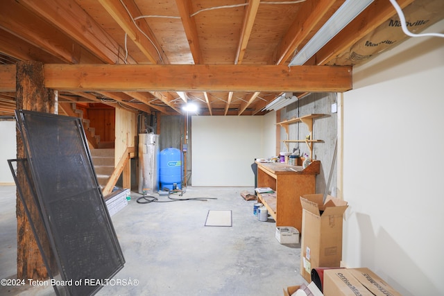 unfinished below grade area with stairs and water heater