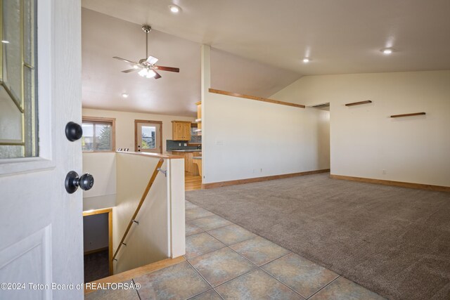 interior space with lofted ceiling and ceiling fan