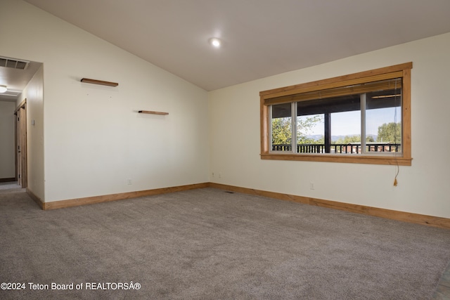 empty room with carpet and lofted ceiling