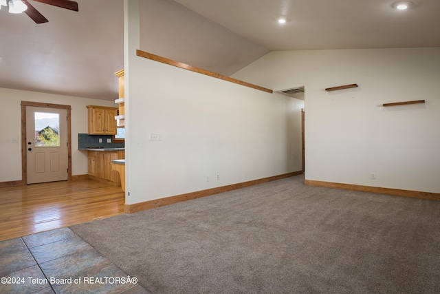 unfurnished living room featuring light hardwood / wood-style floors, lofted ceiling, and ceiling fan