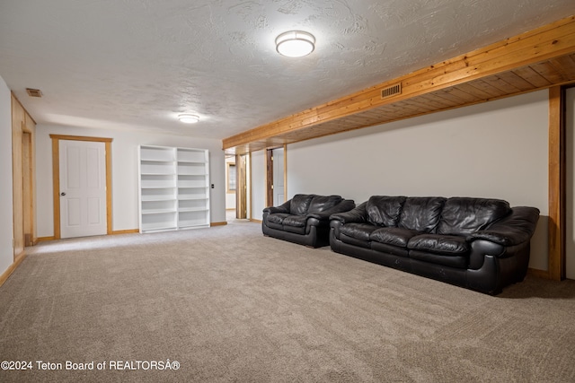 living room featuring a textured ceiling and carpet flooring