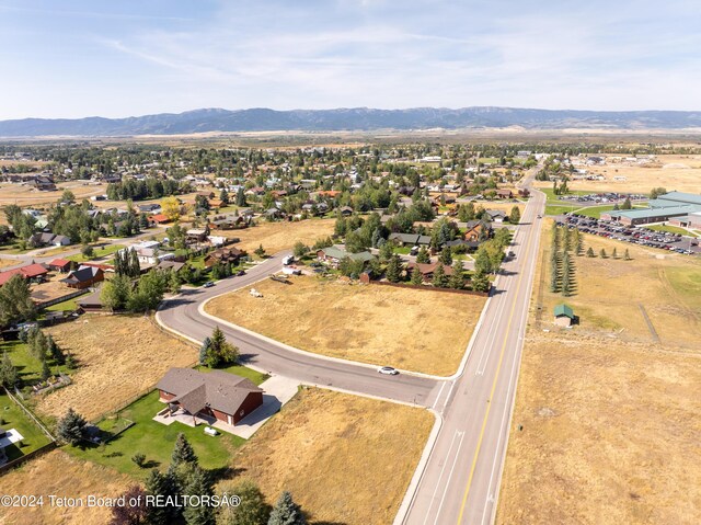 birds eye view of property with a mountain view