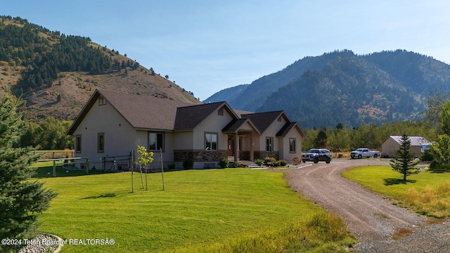 exterior space featuring a front lawn and a mountain view