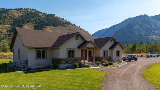 view of front facade with a mountain view and a front yard