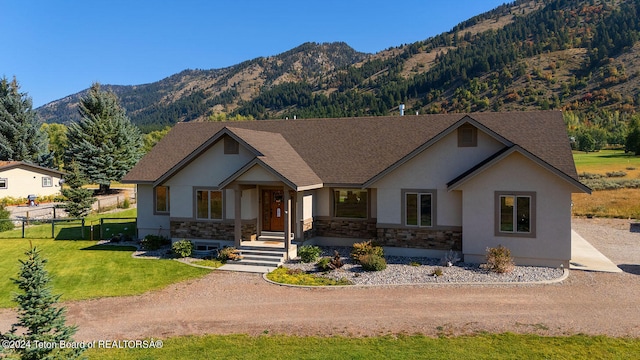 craftsman inspired home with a mountain view and a front lawn