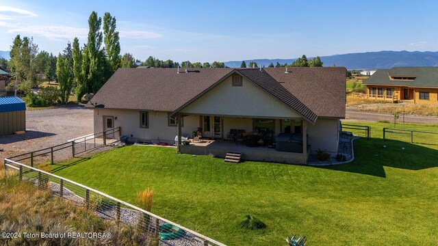 rear view of house featuring a yard, a patio, a mountain view, and outdoor lounge area