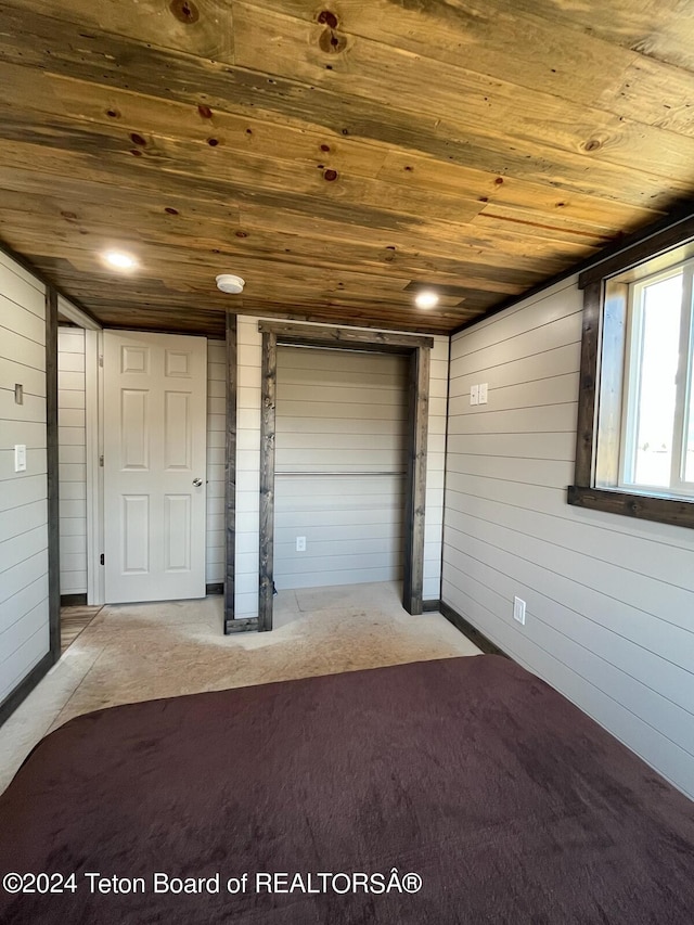 interior space featuring wood walls and wooden ceiling