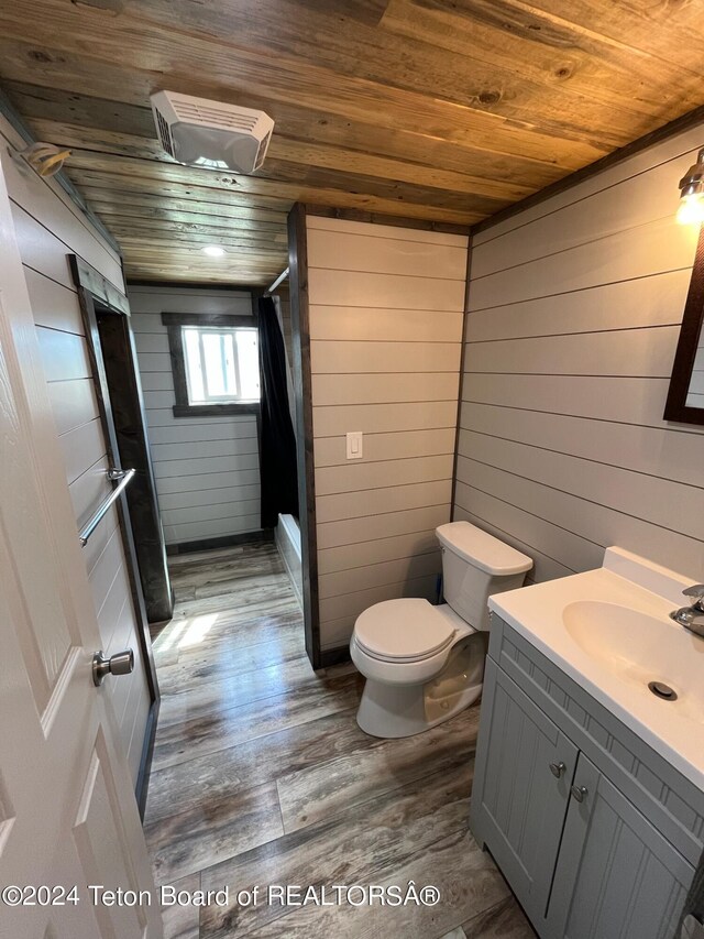 bathroom with wooden ceiling, vanity, hardwood / wood-style floors, and wooden walls