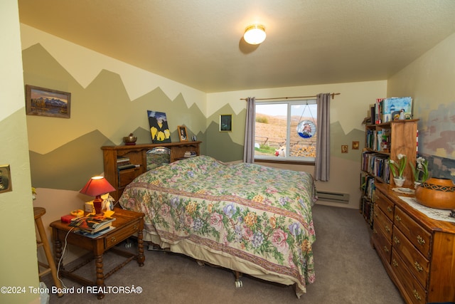 carpeted bedroom with a textured ceiling and a baseboard radiator