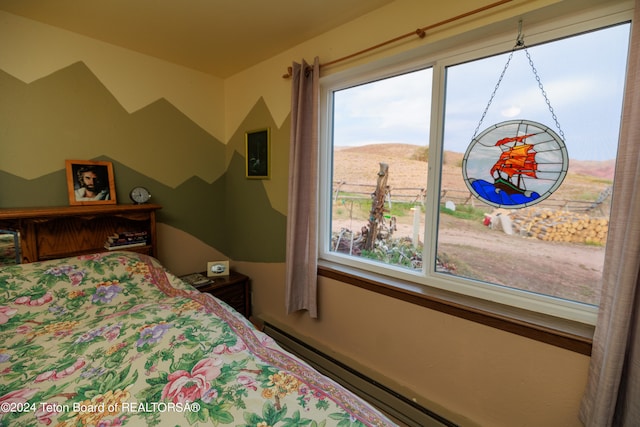 bedroom with a baseboard radiator and a mountain view