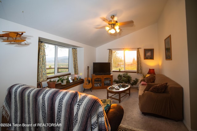 carpeted living room featuring vaulted ceiling and ceiling fan