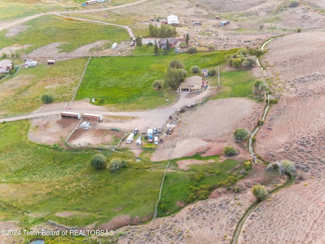 birds eye view of property with a rural view