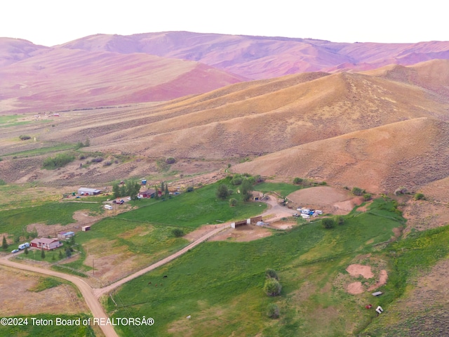 aerial view with a mountain view and a rural view