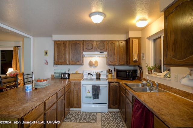 kitchen featuring a textured ceiling, sink, electric stove, and light tile patterned floors