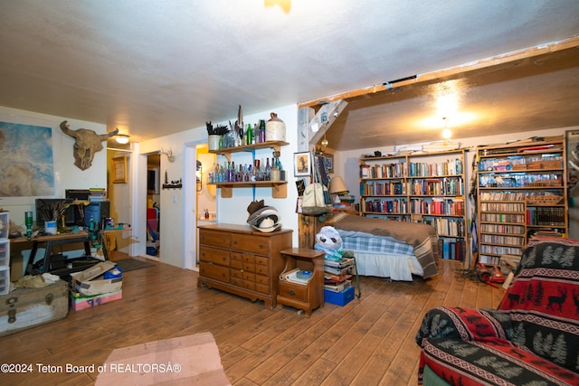 bedroom with a textured ceiling and hardwood / wood-style floors