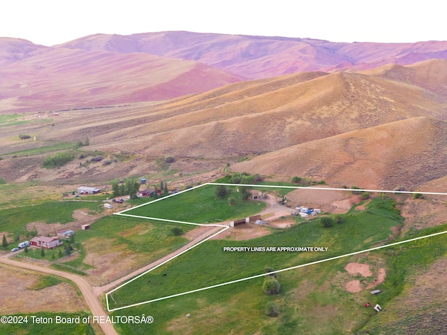 birds eye view of property featuring a mountain view and a rural view