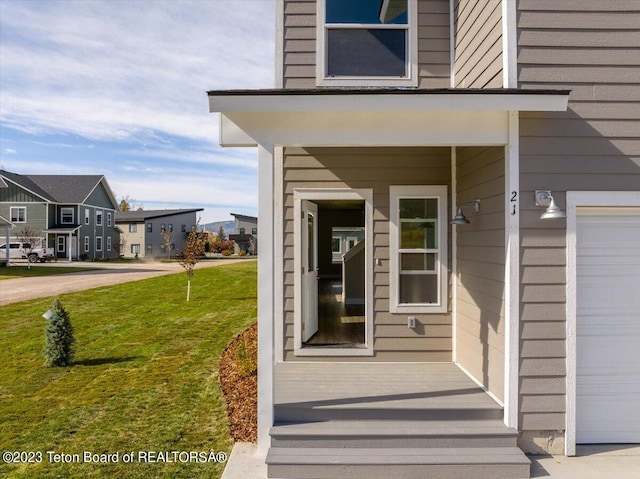 view of exterior entry featuring a lawn