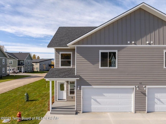 view of front of house featuring a garage and a front lawn